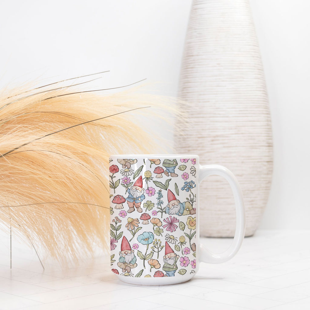 Mug with gnome and floral pattern on a white surface with a blurred background