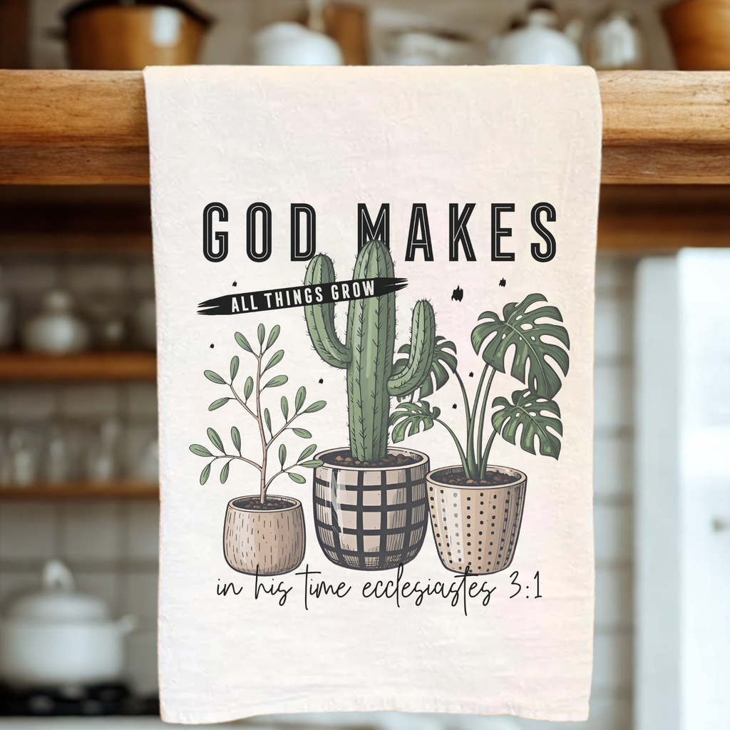 Tea towel with plant illustration and text hanging on a wooden rack.