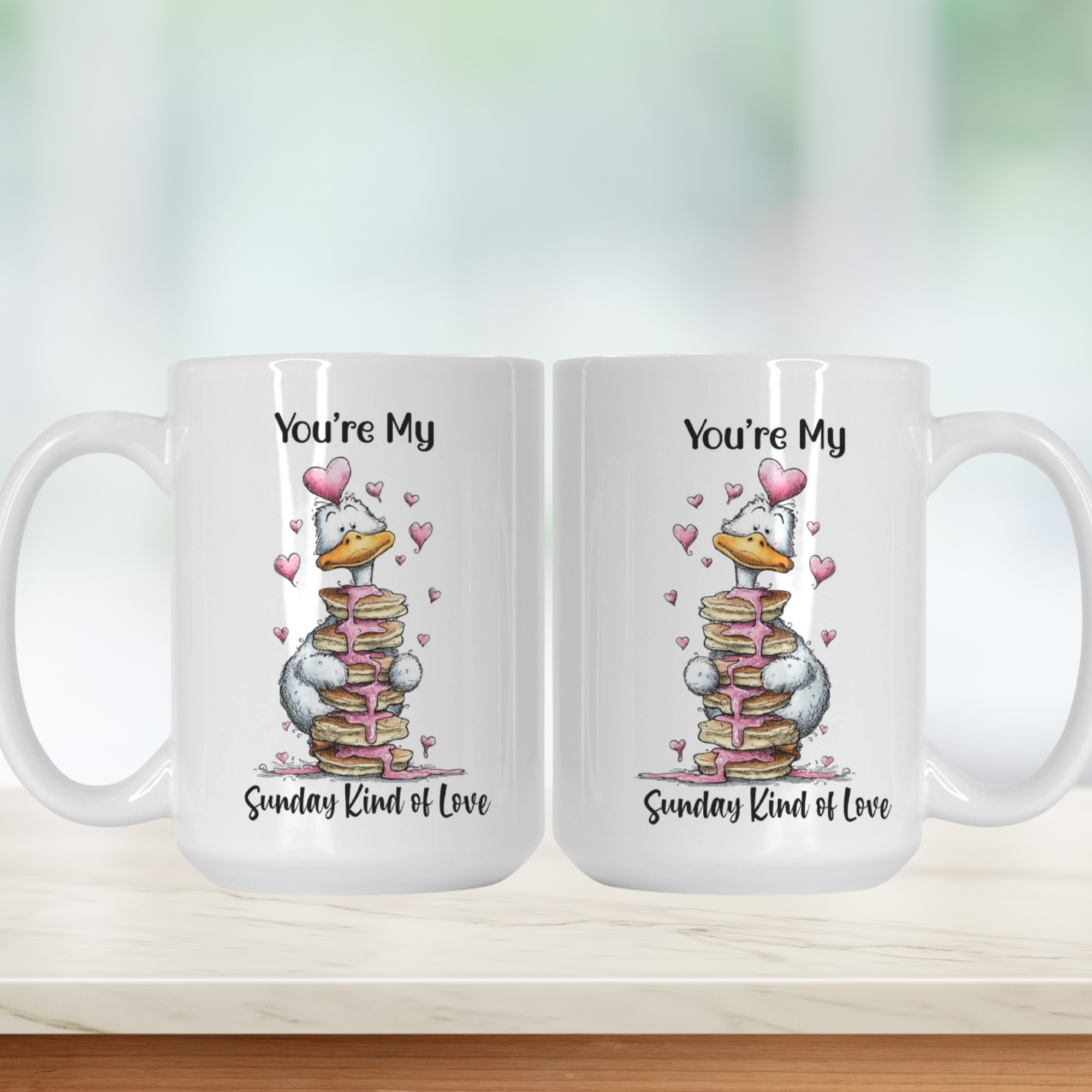 Two white mugs with cartoon goose design and text on a light background
