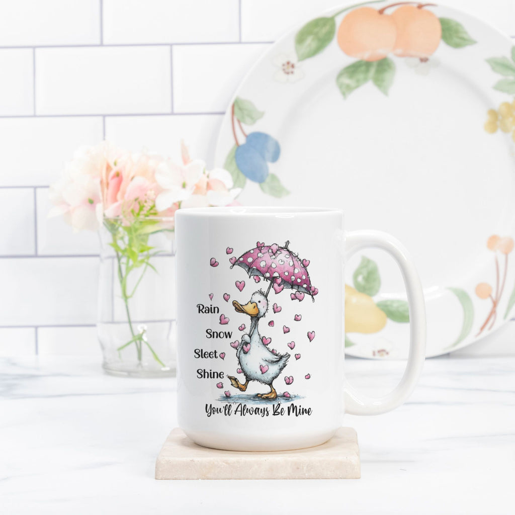 Mug with a cartoon goose holding an umbrella and hearts, placed on a wooden coaster with a decorative plate in the background.