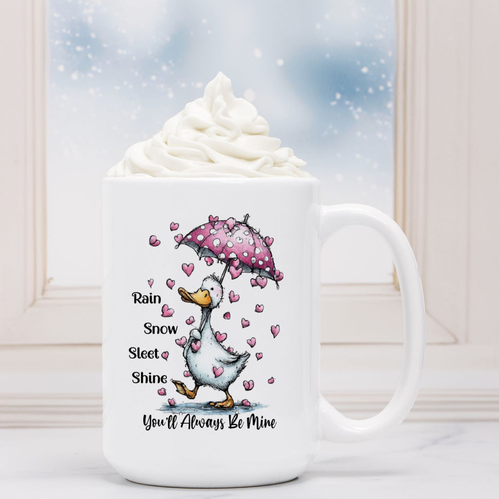 White mug with a duck holding a pink umbrella and hearts, text 'Rain Snow Sleet Shine You'll Always Be Mine' on a snowy background.