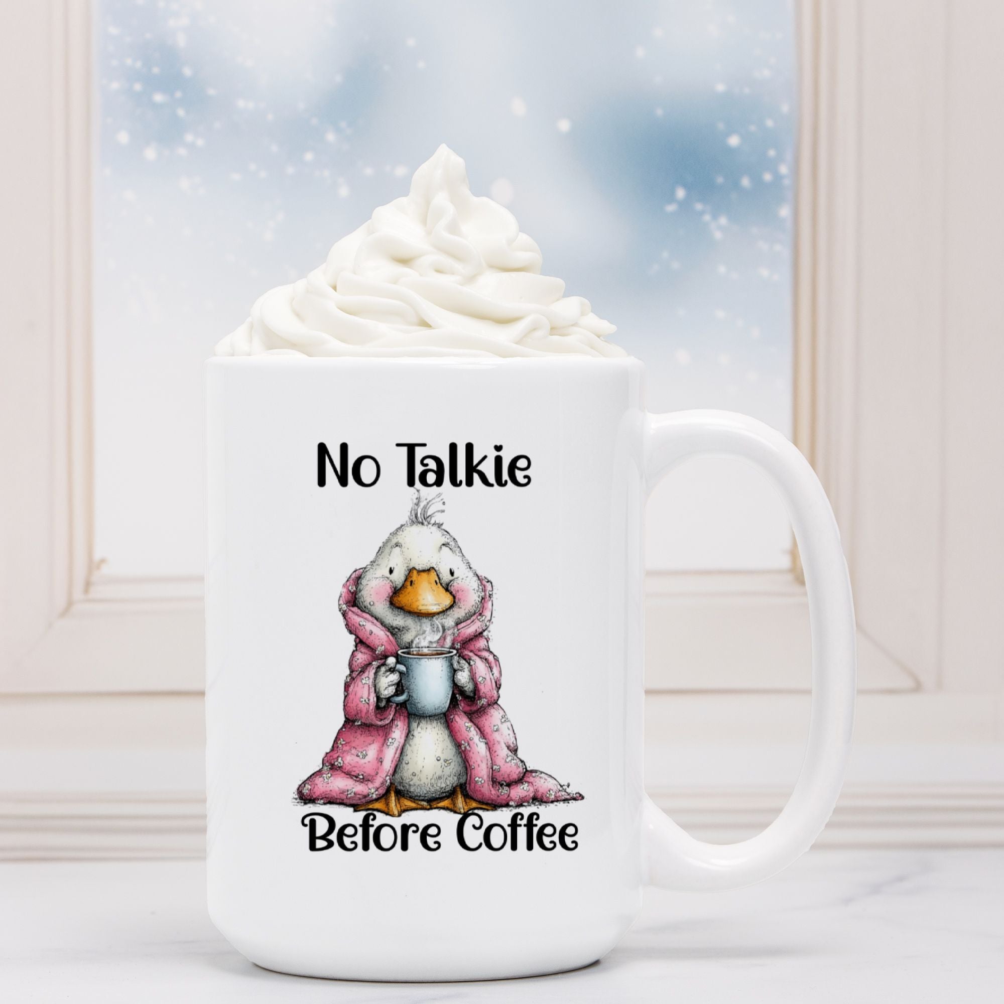 White mug with a cartoon duck in a pink robe holding a coffee cup, text 'No Talkie Before Coffee', against a snowy window background.