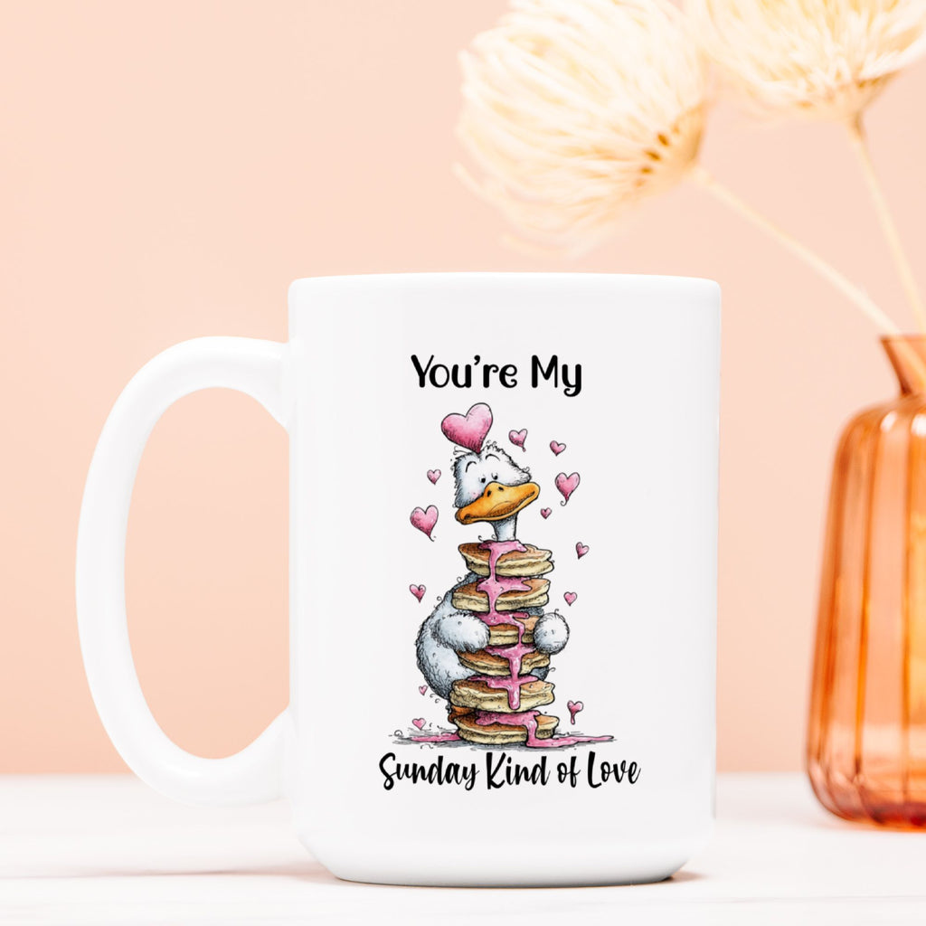 White mug with cartoon character goose and text' You're My Sunday Kind Of Love' on a light pink background