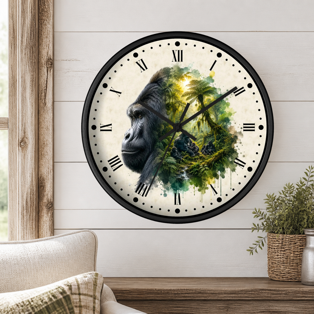 A round wall clock with a black frame and Roman numerals, featuring a split design of a gorilla face on the left and a green jungle scene on the right, mounted on a white wood-paneled wall above a wooden shelf with a plant.