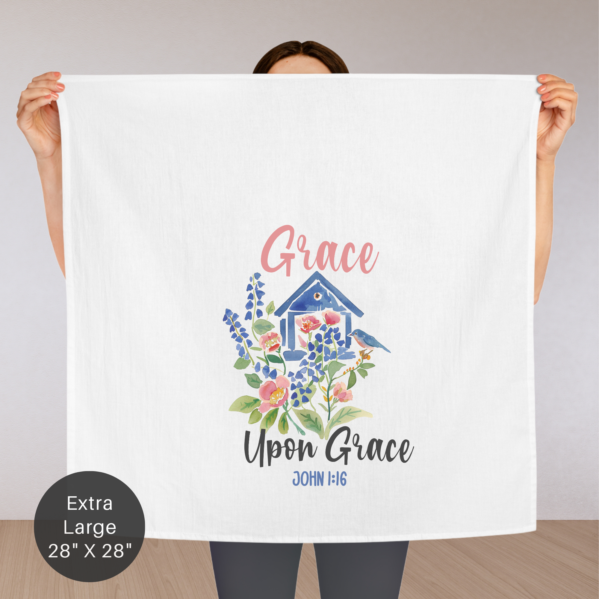 Person holding an extra large tea towel with 'Grace Upon Grace' design and text.