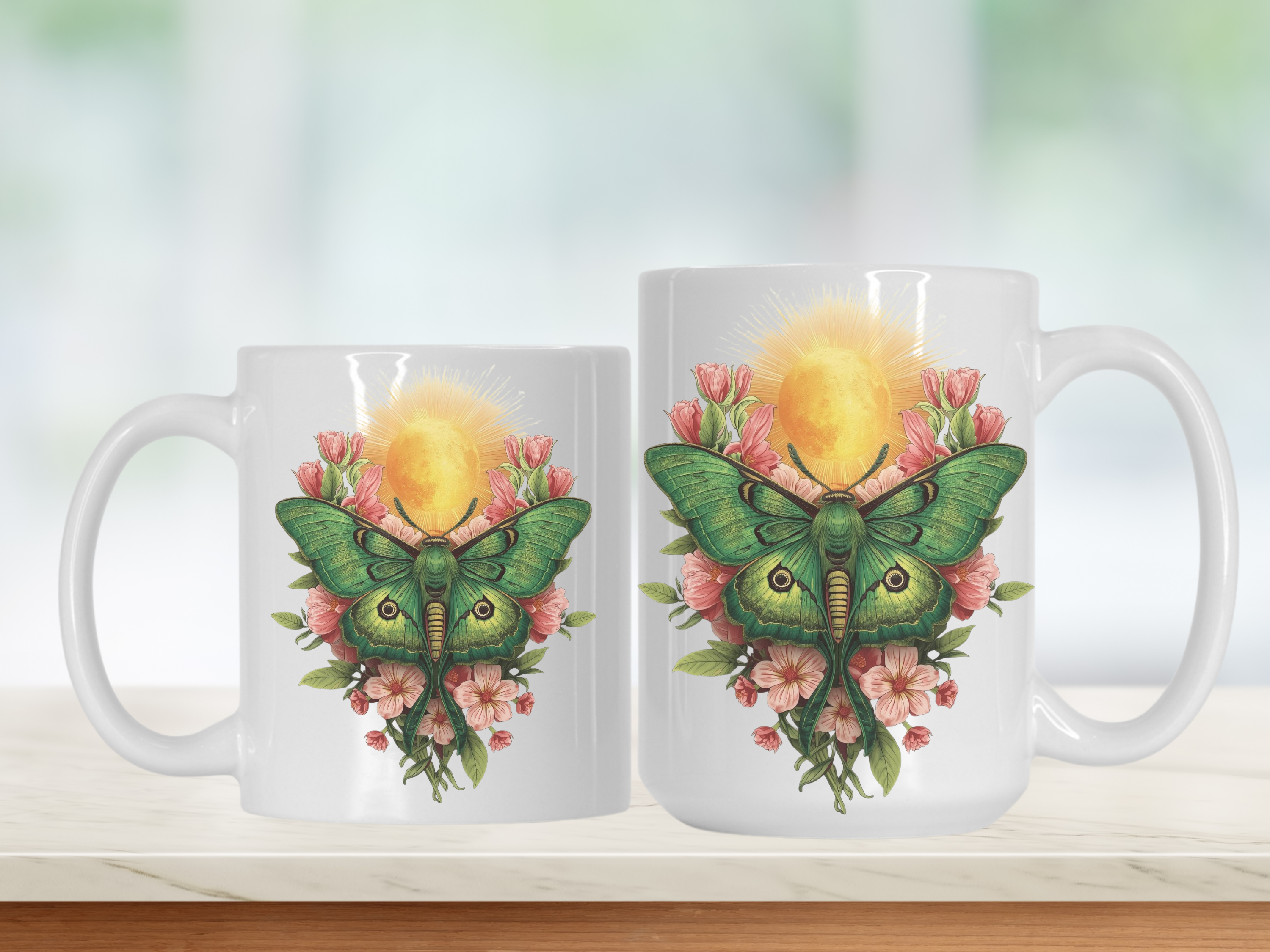 Two mugs with a design of a green lunar moth and flowers on a white background
