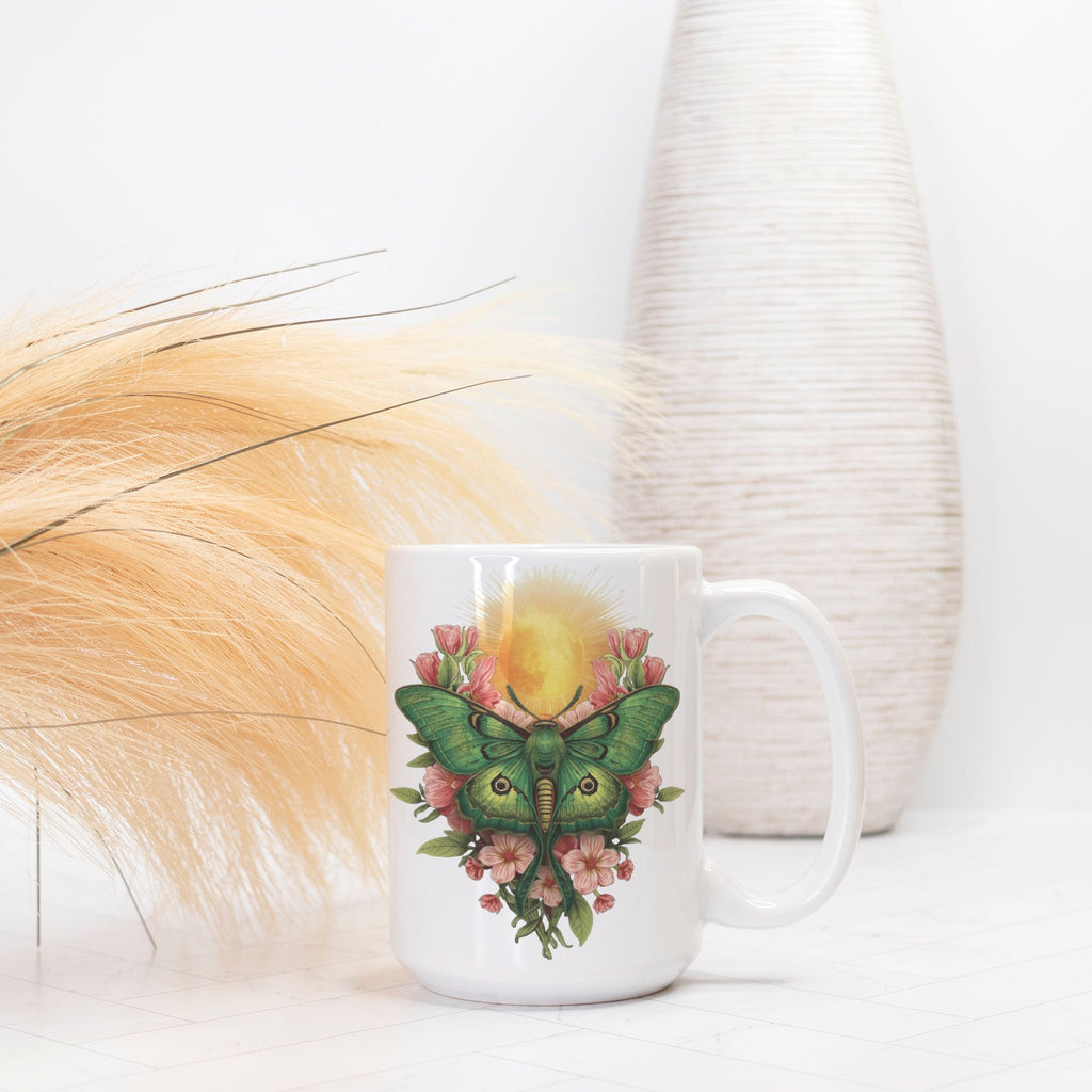 White mug with a green moth and pink flowers design on a white background