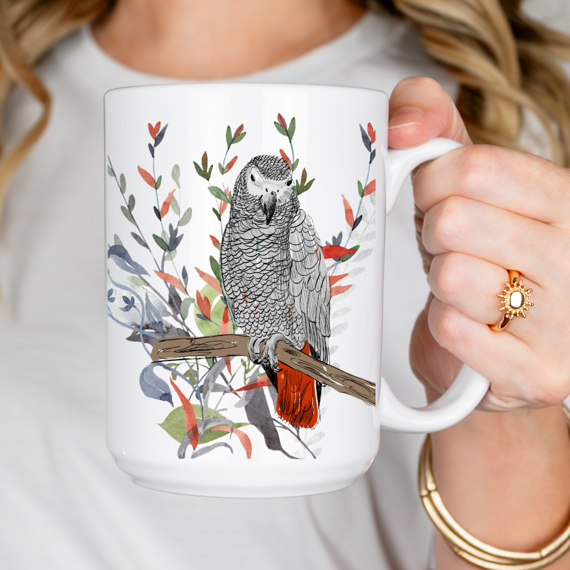 Person holding a mug with a parrot design on a white background