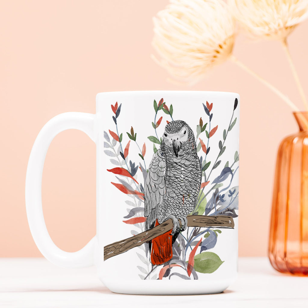White mug with a parrot design on a light pink background