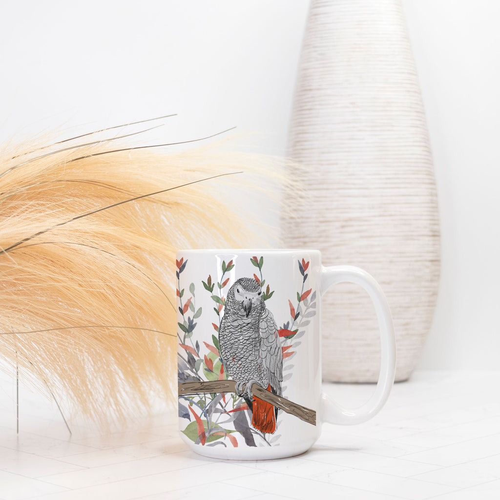Mug with a parrot design on a white surface with decorative elements