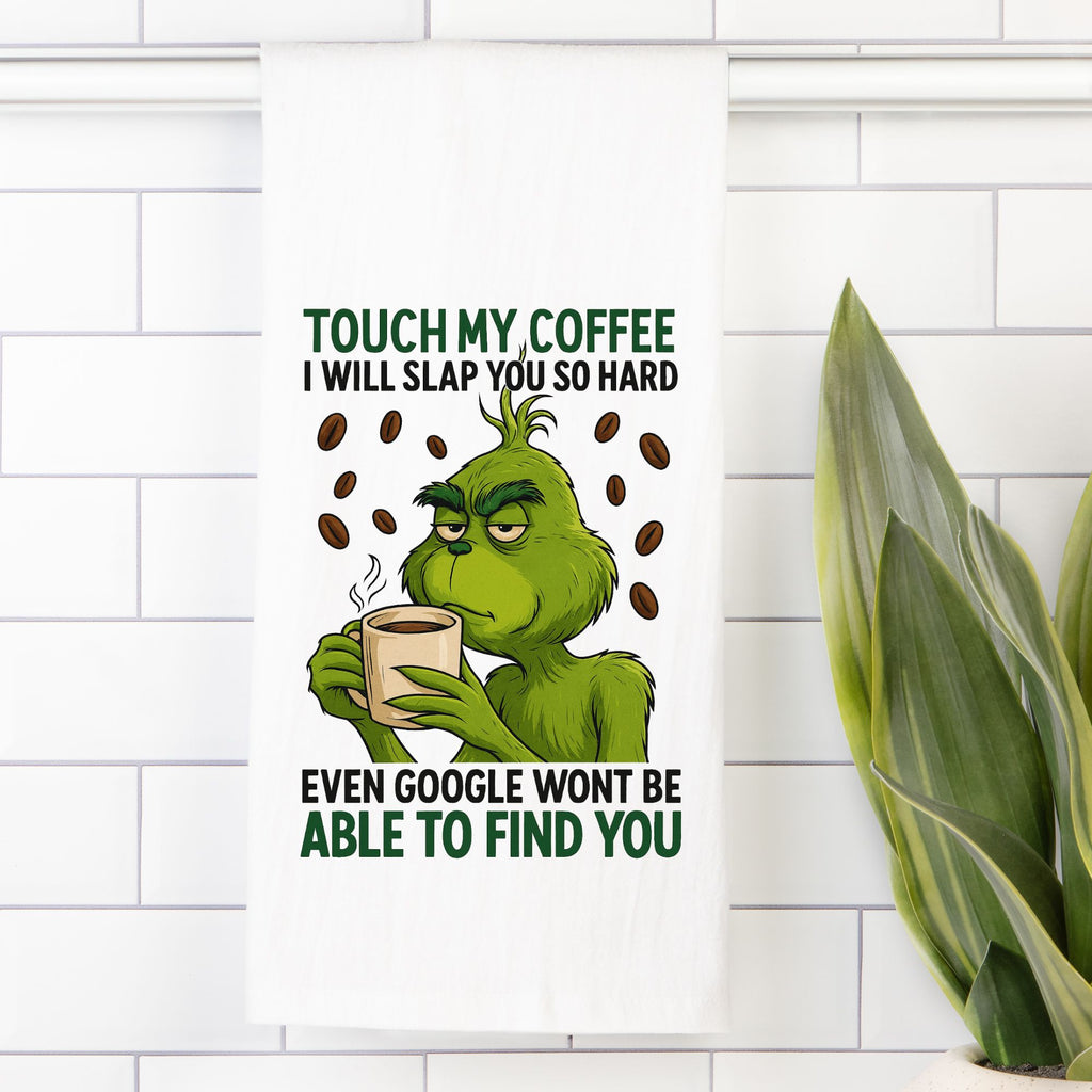 Cartoon Grinch character holding a coffee cup with humorous text on a white tiled wall.
