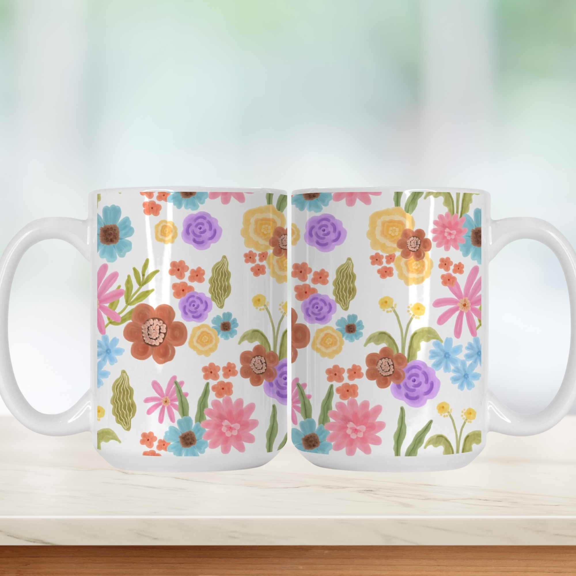 Two floral-patterned mugs on a light background