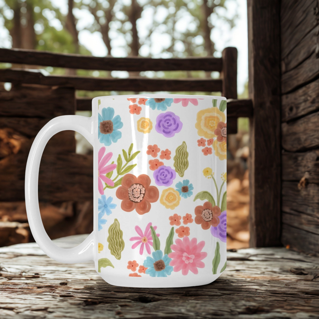White mug with colorful floral pattern on a wooden surface outdoors