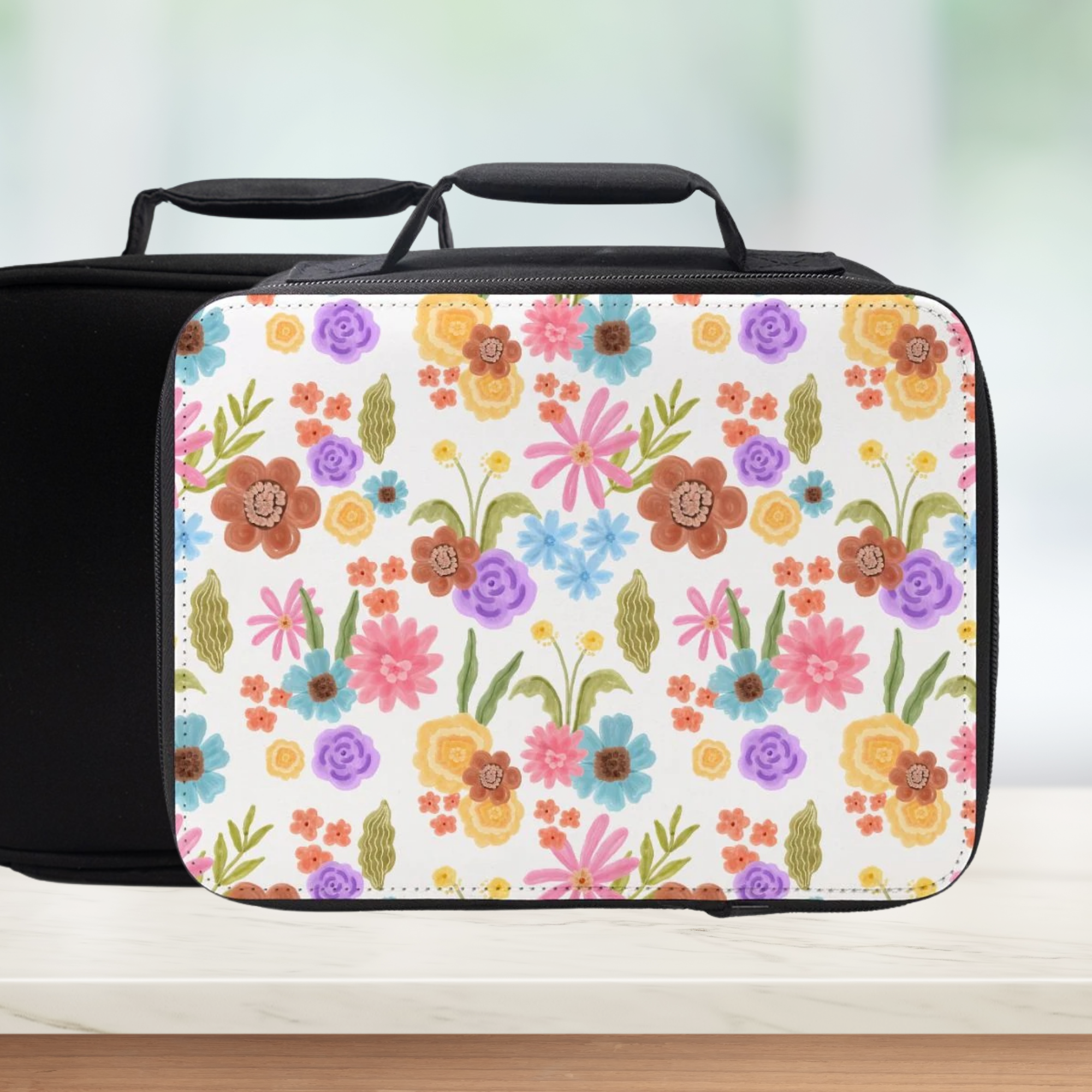 Floral-patterned lunch bag on a wooden surface with a blurred background