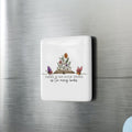Decorative magnet with floral design and text on a refrigerator