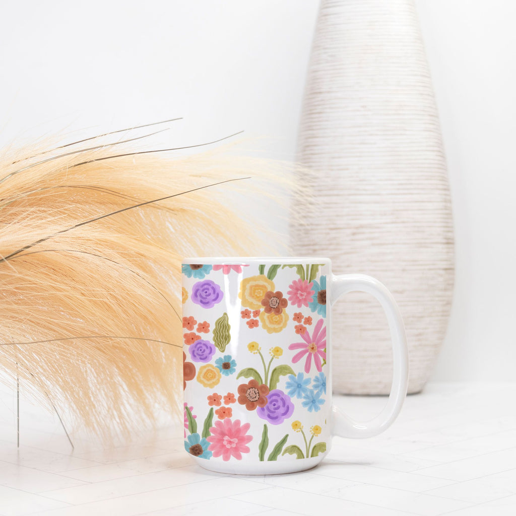 Floral-patterned mug on a white surface with a blurred background