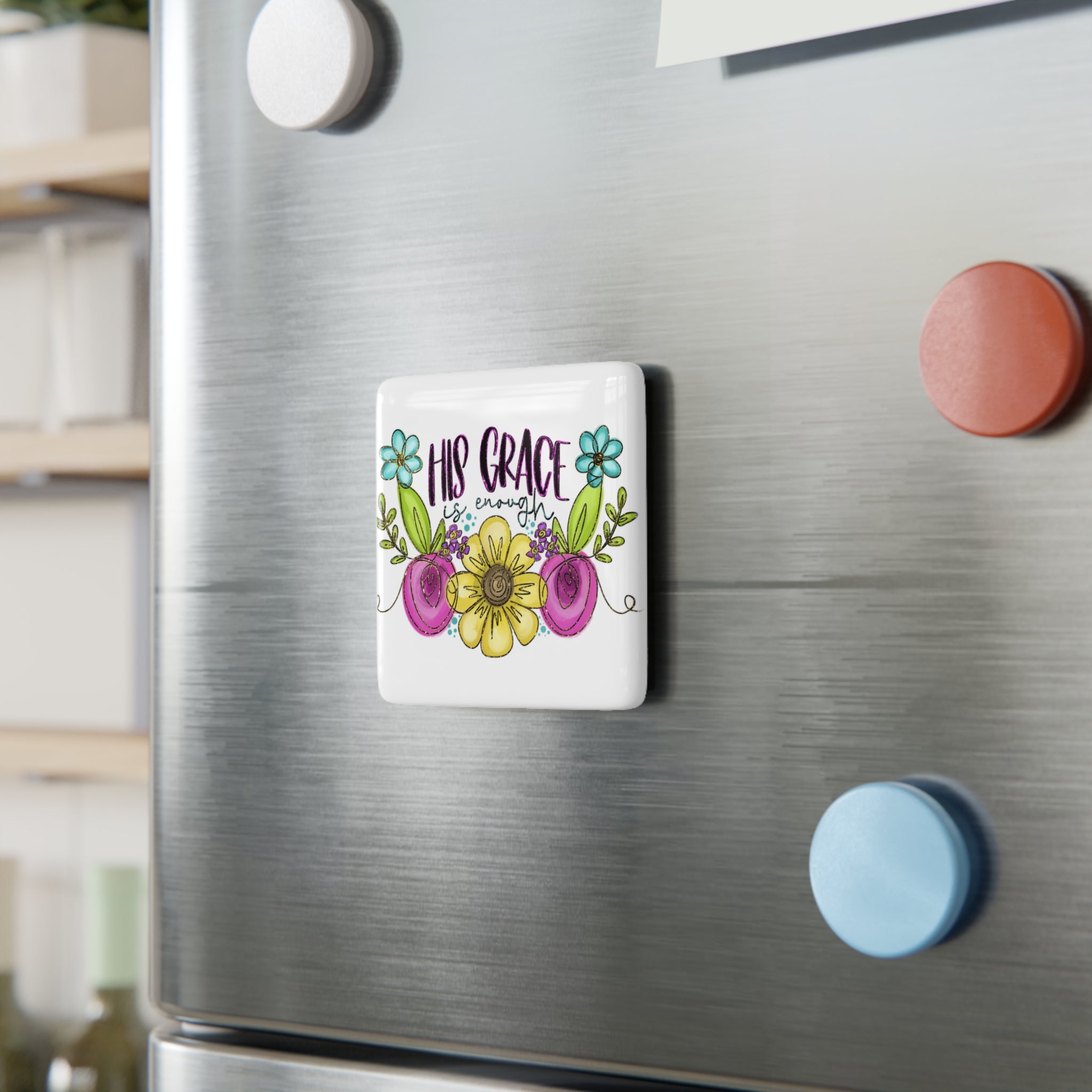 Decorative porcelain magnet with floral design and text on a refrigerator