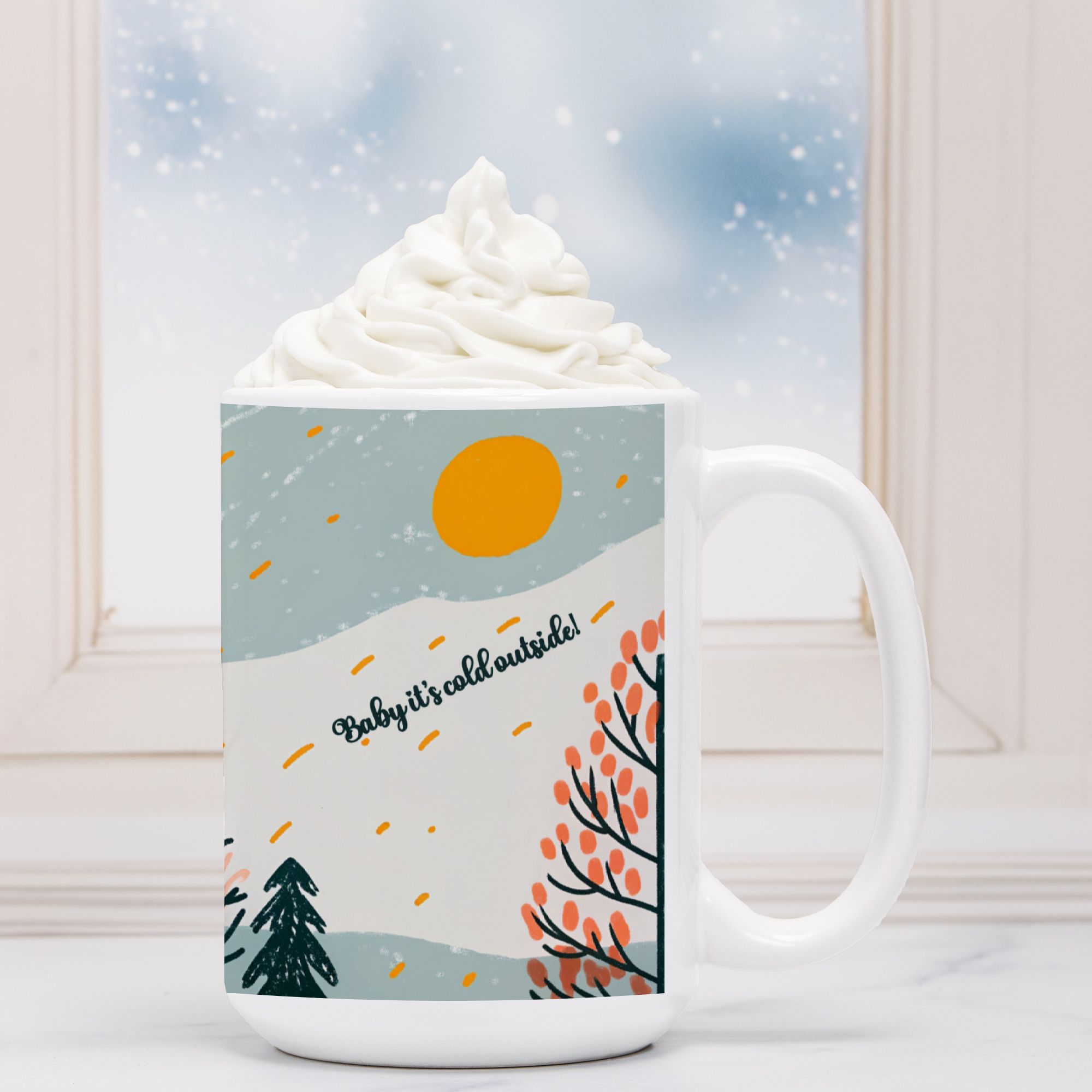 White mug with winter scene design featuring trees and sun, filled with hot chocolate and whipped cream.