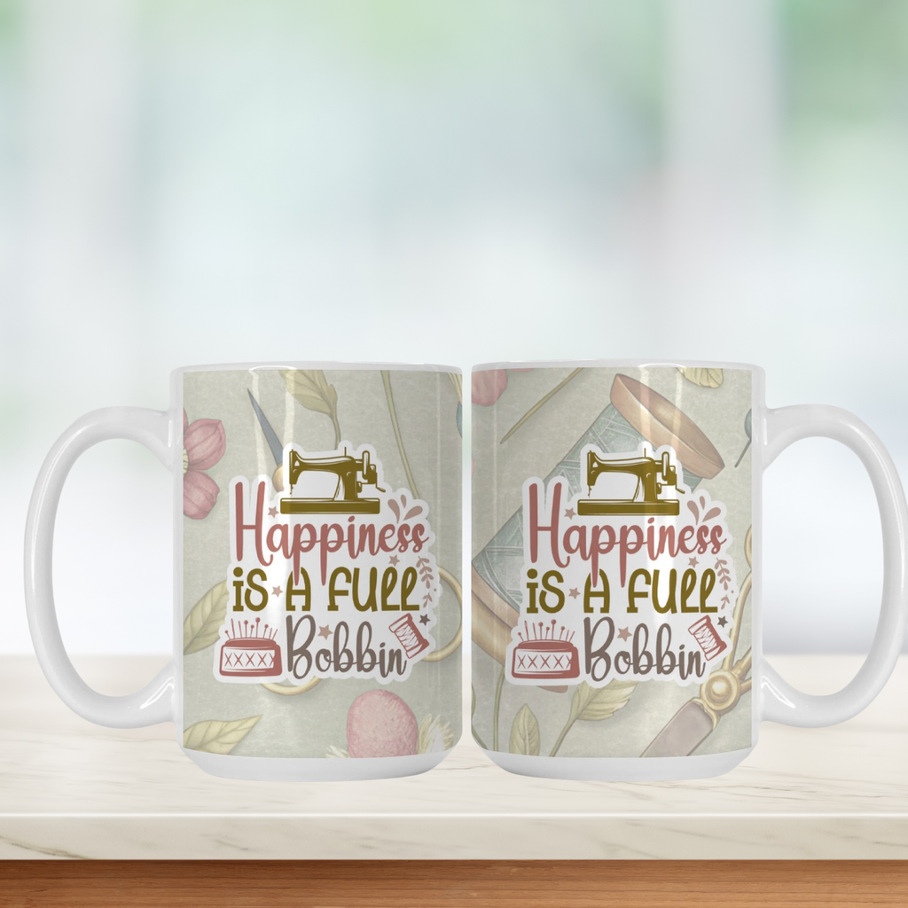 Two mugs with a sewing-themed design and 'Happiness is a Full Bobbin' text on a light background.