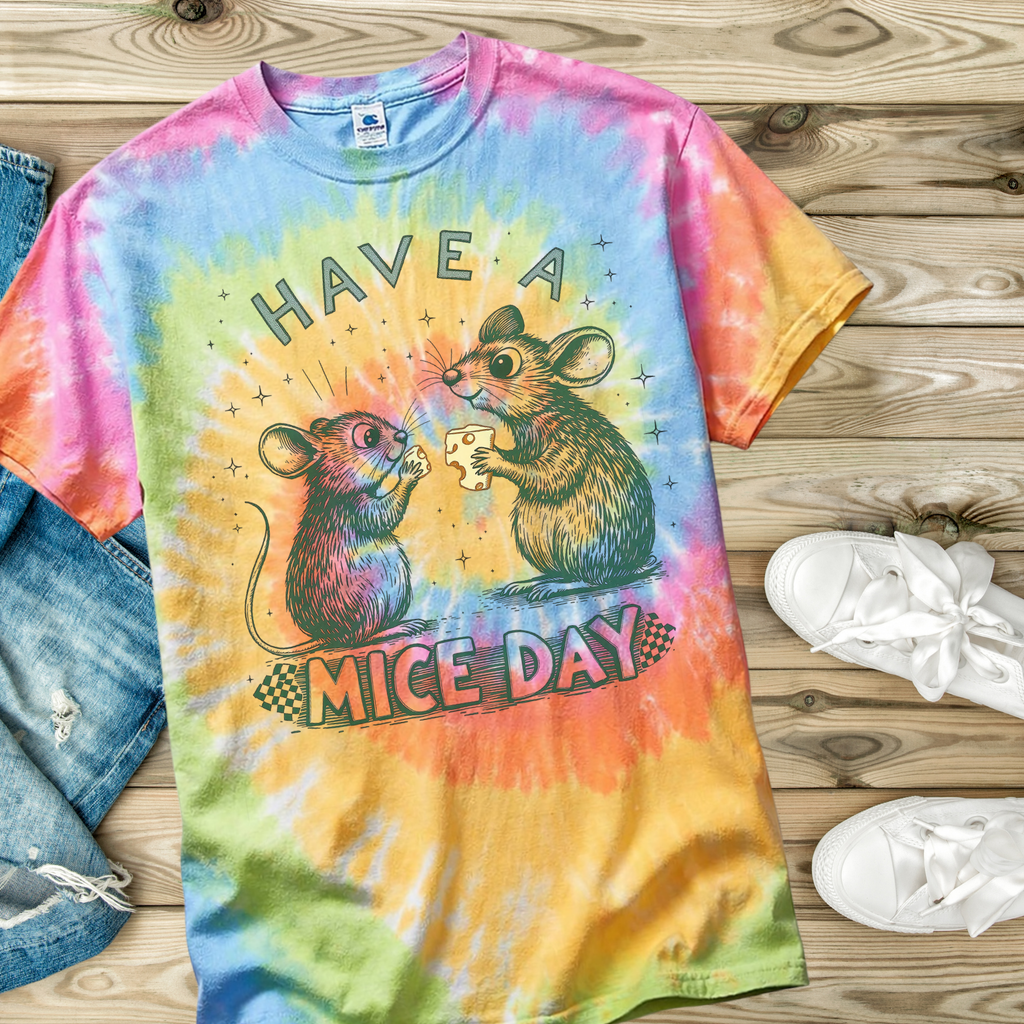 Colorful tie-dye t-shirt with mouse design and text 'Have a Mice Day' on a wooden surface.