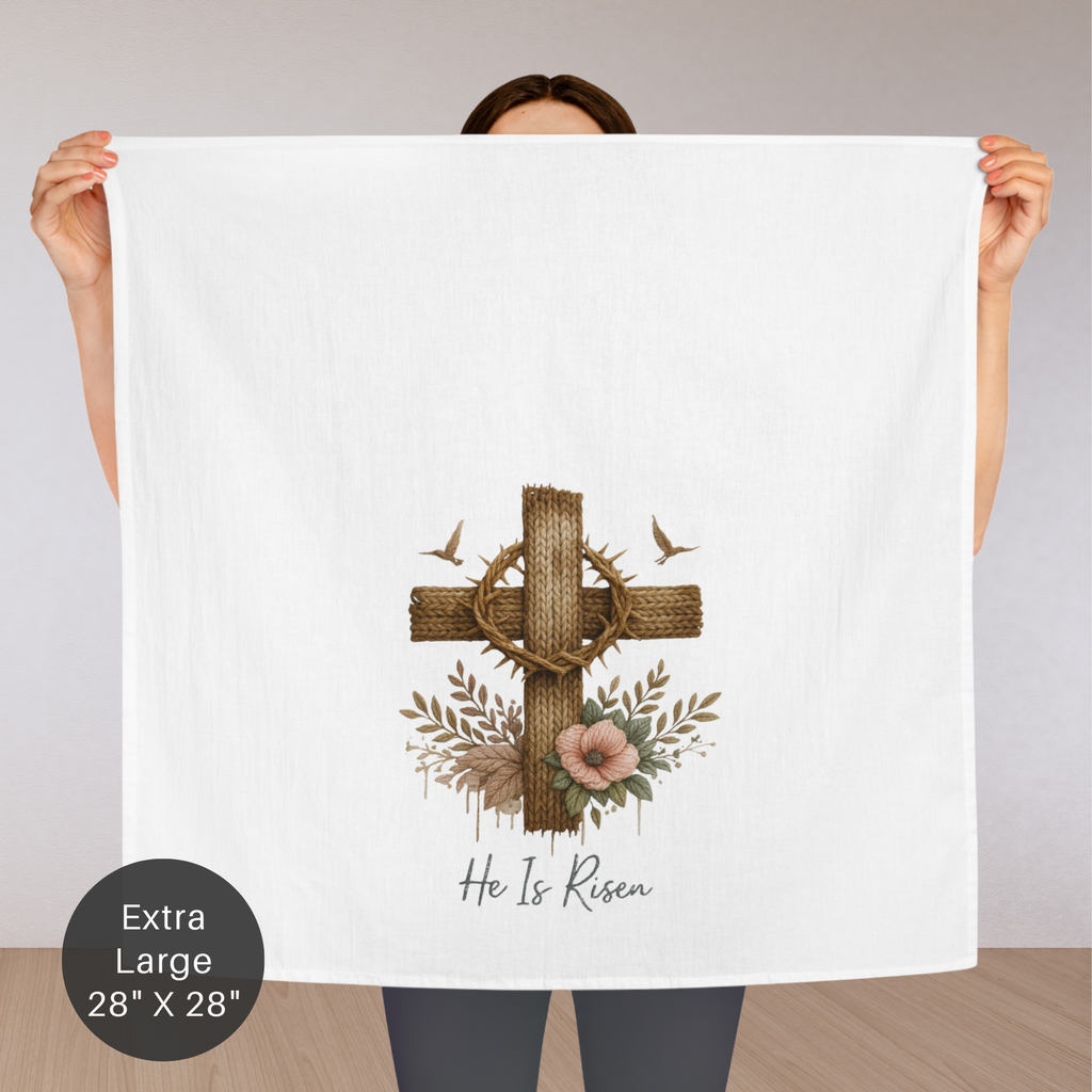 Person holding a large white tea towel with a cross, crown of thorns, and flowers design.