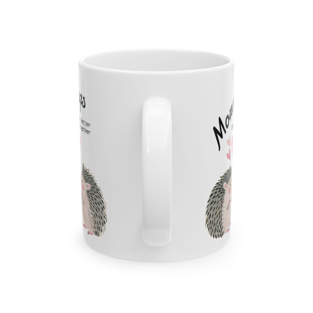 handle view of an 11 oz ceramic mug with a hedgehog couple design on a white background.