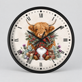 A round wall clock with a black frame and a cream-colored face featuring a whimsical illustration of a Highland cow and a gnome in a plaid outfit, surrounded by winter foliage and gifts.