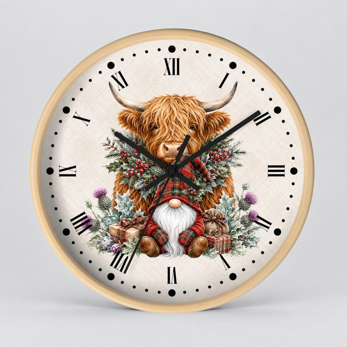 A round wall clock with a light wood frame and a whimsical illustration of a Highland cow wearing a red plaid sweater, surrounded by a festive wreath and a white-bearded gnome, on a light gray background.