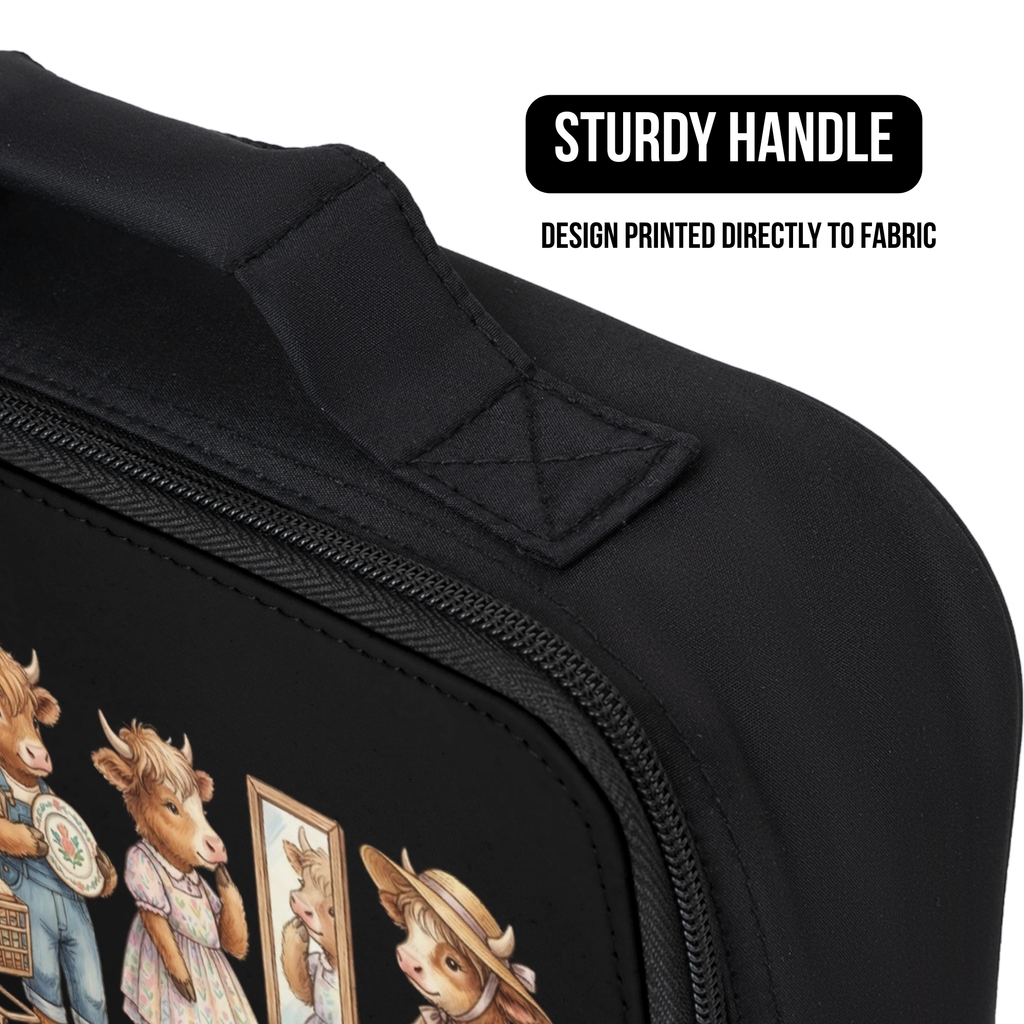 Black lunch bag with cow design printed directly to the fabric and sturdy handle feature