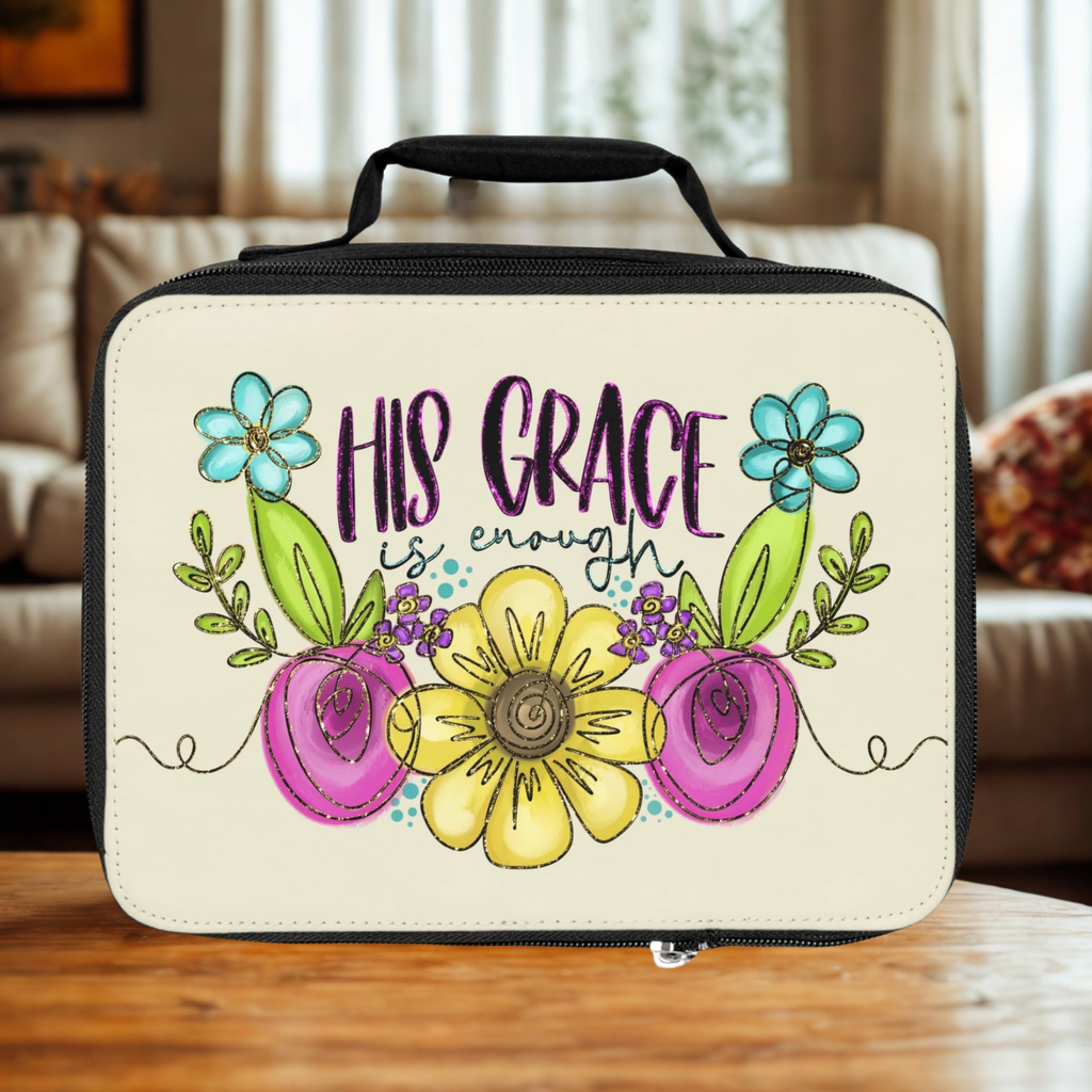  insulated lunch bag with floral design and 'His Grace is Enough' text on a wooden surface.