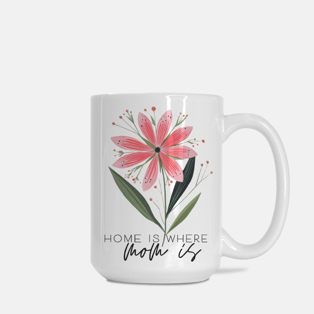 White mug with pink floral design and text 'Home is where Mom is' on a white background