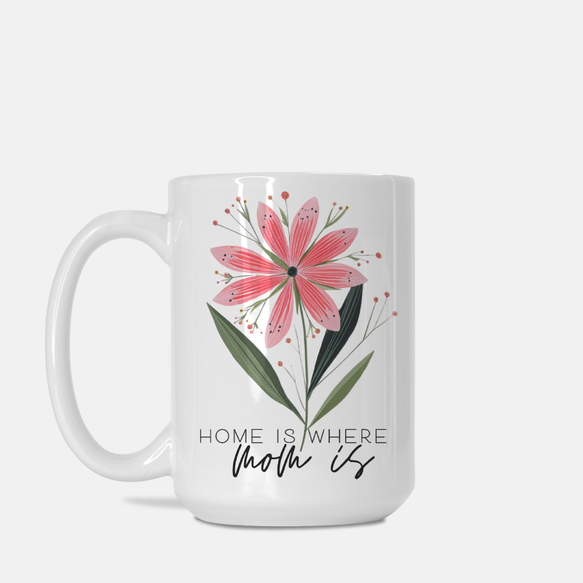 White mug with pink floral design and 'Home is where mom is' text on a white background