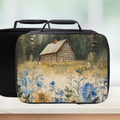 Black lunch bag with a cabin and floral design on a white background