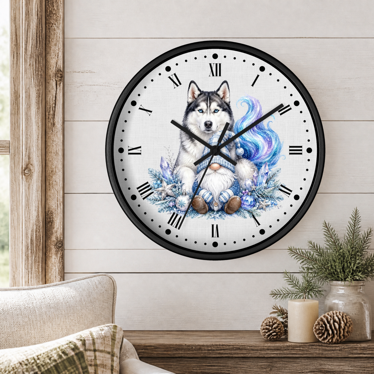 A round wall clock with a black frame and a white face featuring a detailed illustration of a husky dog with a blue and purple fluffy tail, styled on a light wood paneled wall above a wooden table with a candle and pinecones.
