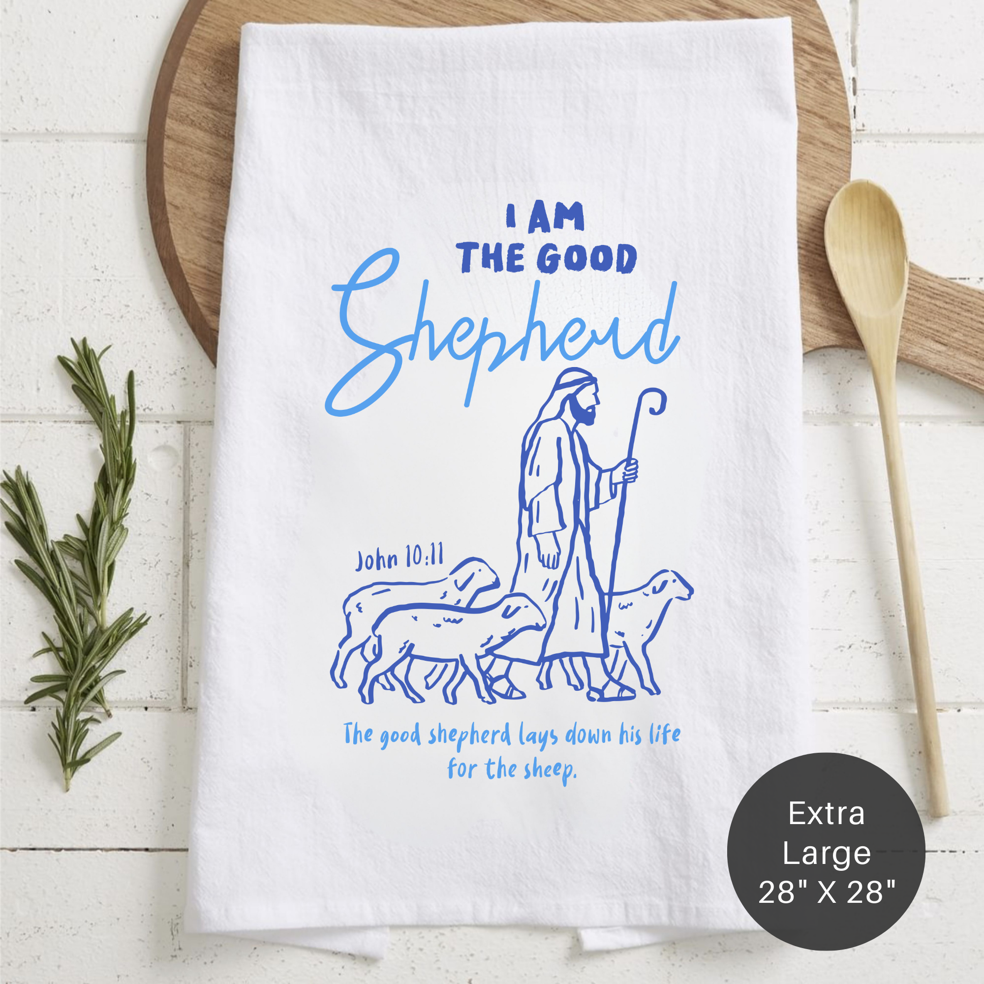 White tea towel with blue illustration and text on a wooden surface