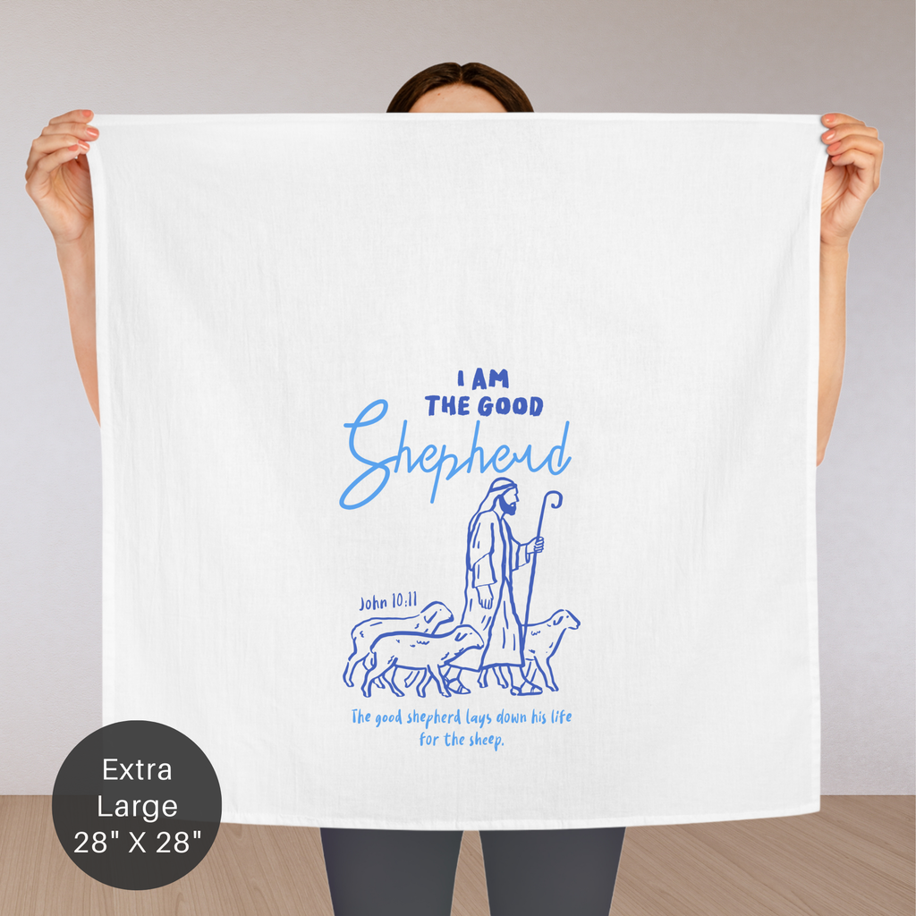 Person holding an extra large white tea towel with blue text and illustration of a shepherd.