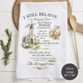 Tea towel with religious quote and church illustration on a wooden surface