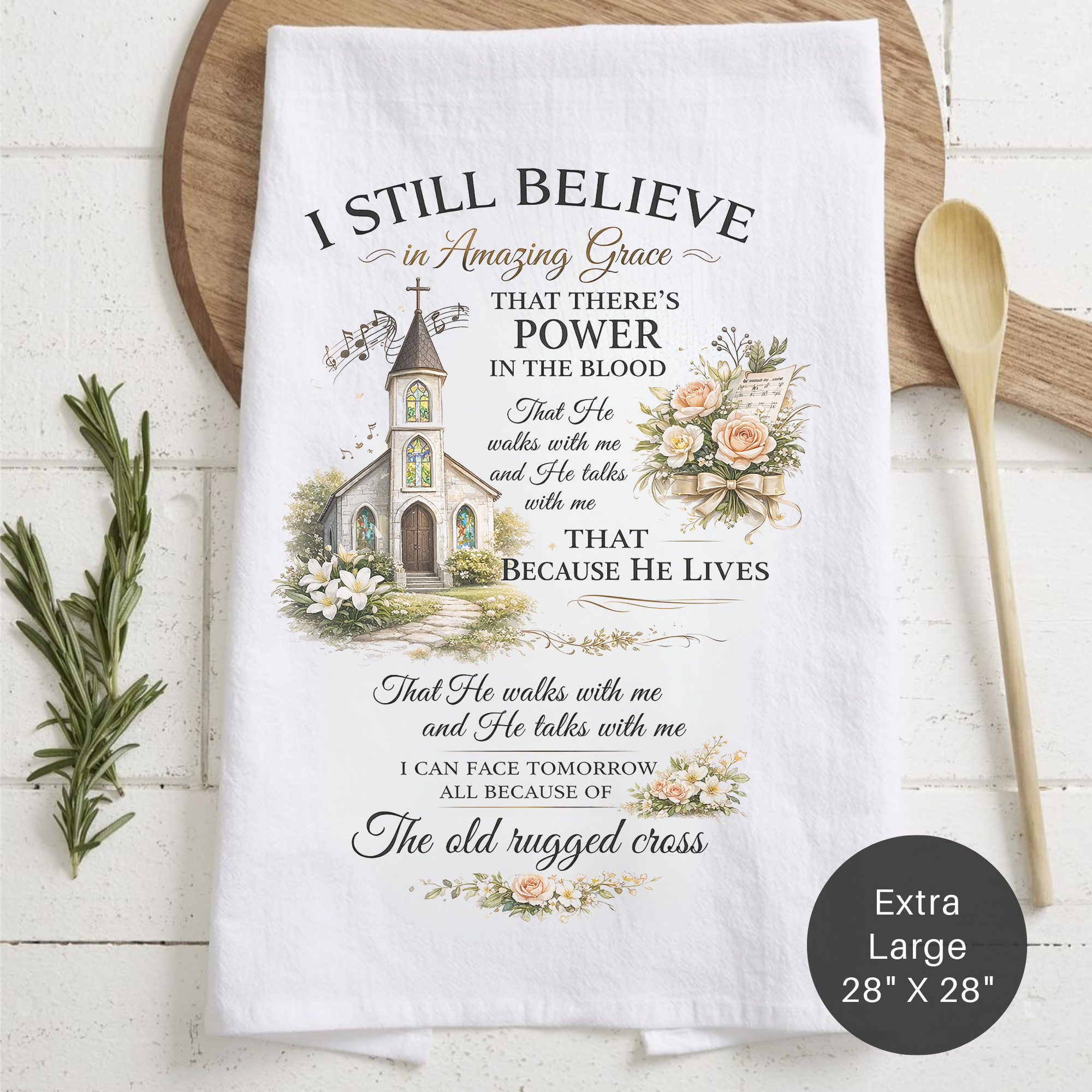 Tea towel with religious quote and church illustration on a wooden surface