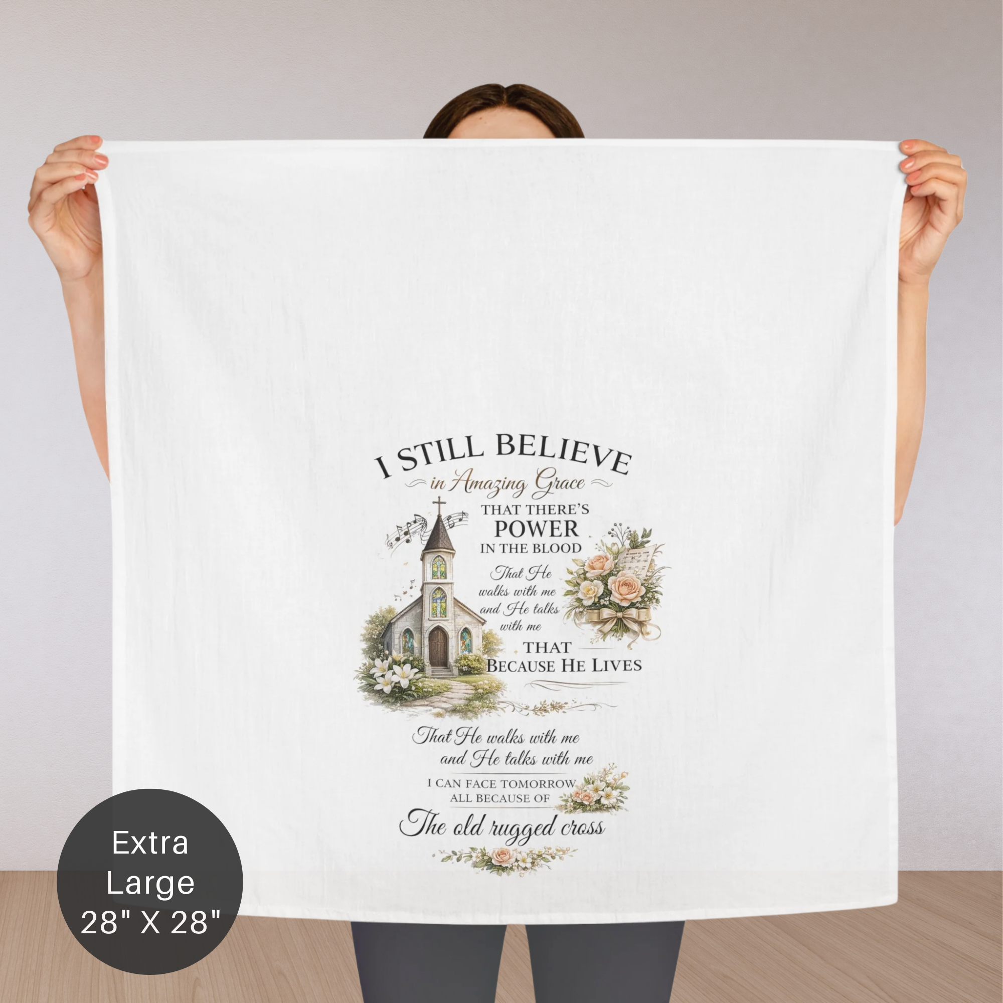 Person holding an extra large tea towel  with a religious quote and design.
