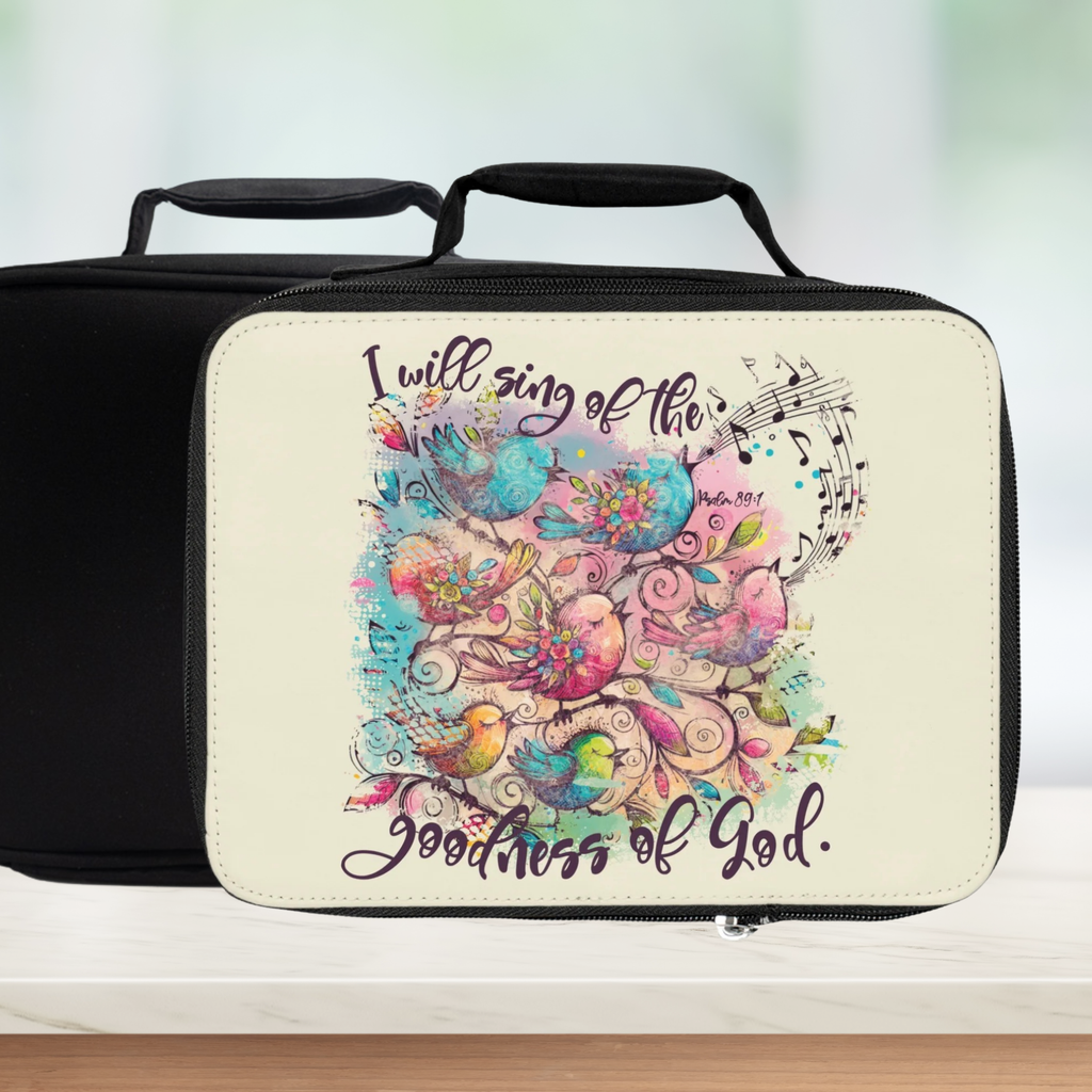 Lunch bag with colorful bird design and text 'I will sing of the goodness of God' on a white background