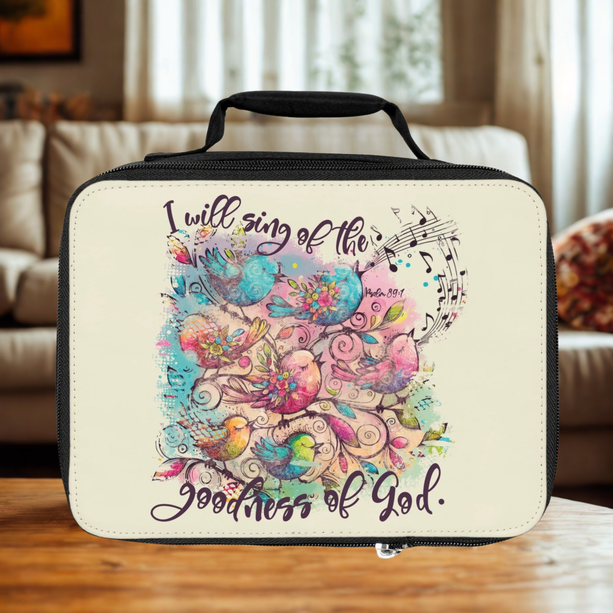  insulated lunch bag with colorful bird design and text on a wooden coffee table 