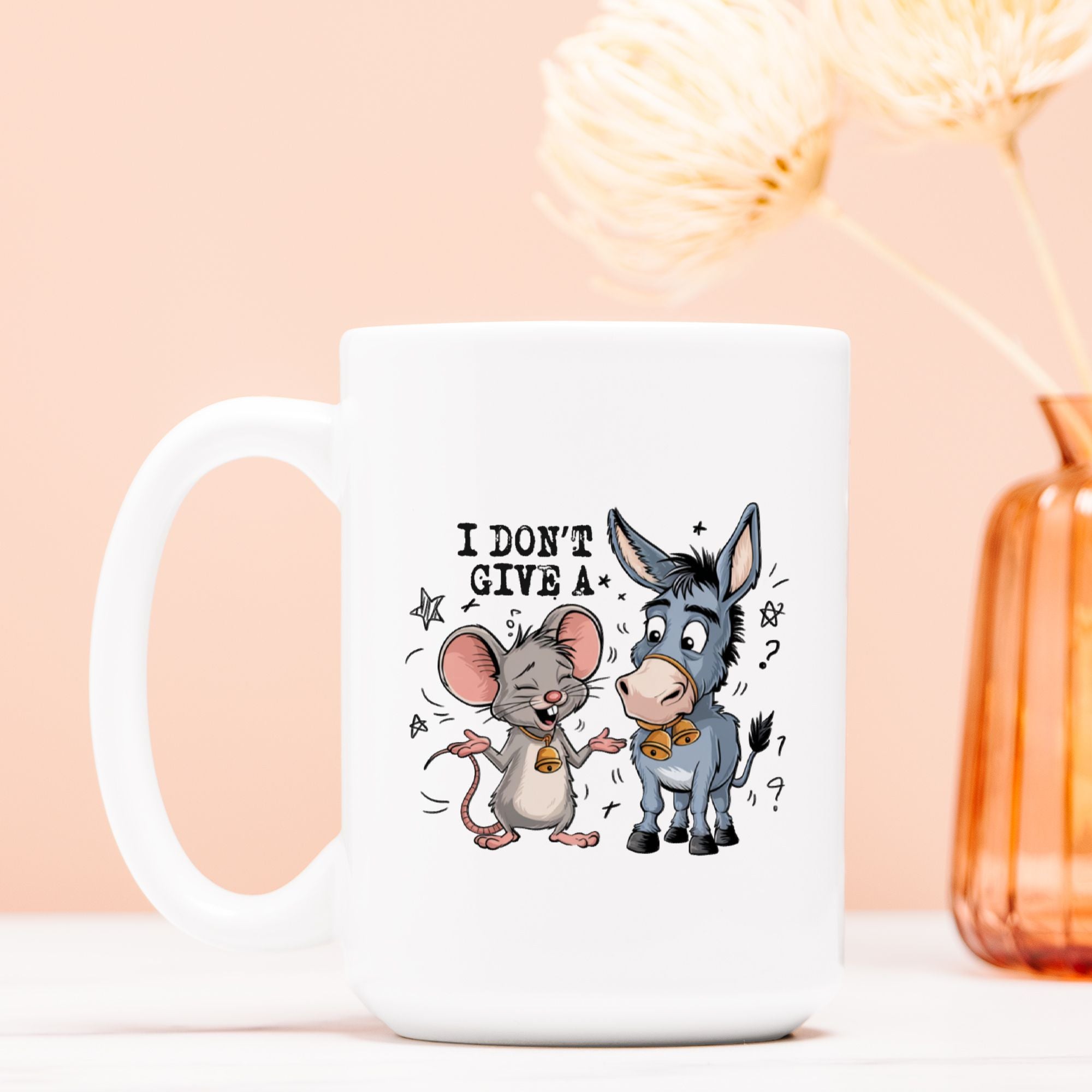 White mug with cartoon mouse and donkey design on a light pink background