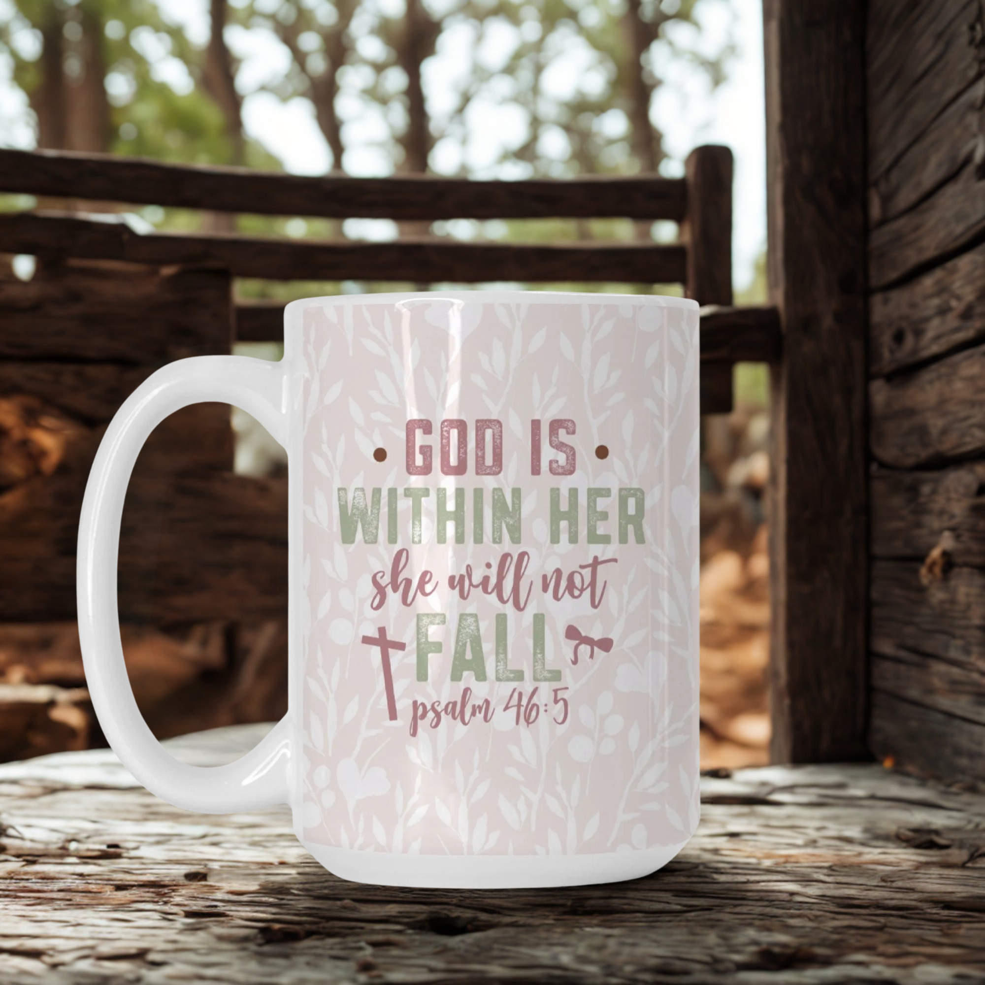 White mug with motivational quote on a wooden surface outdoors