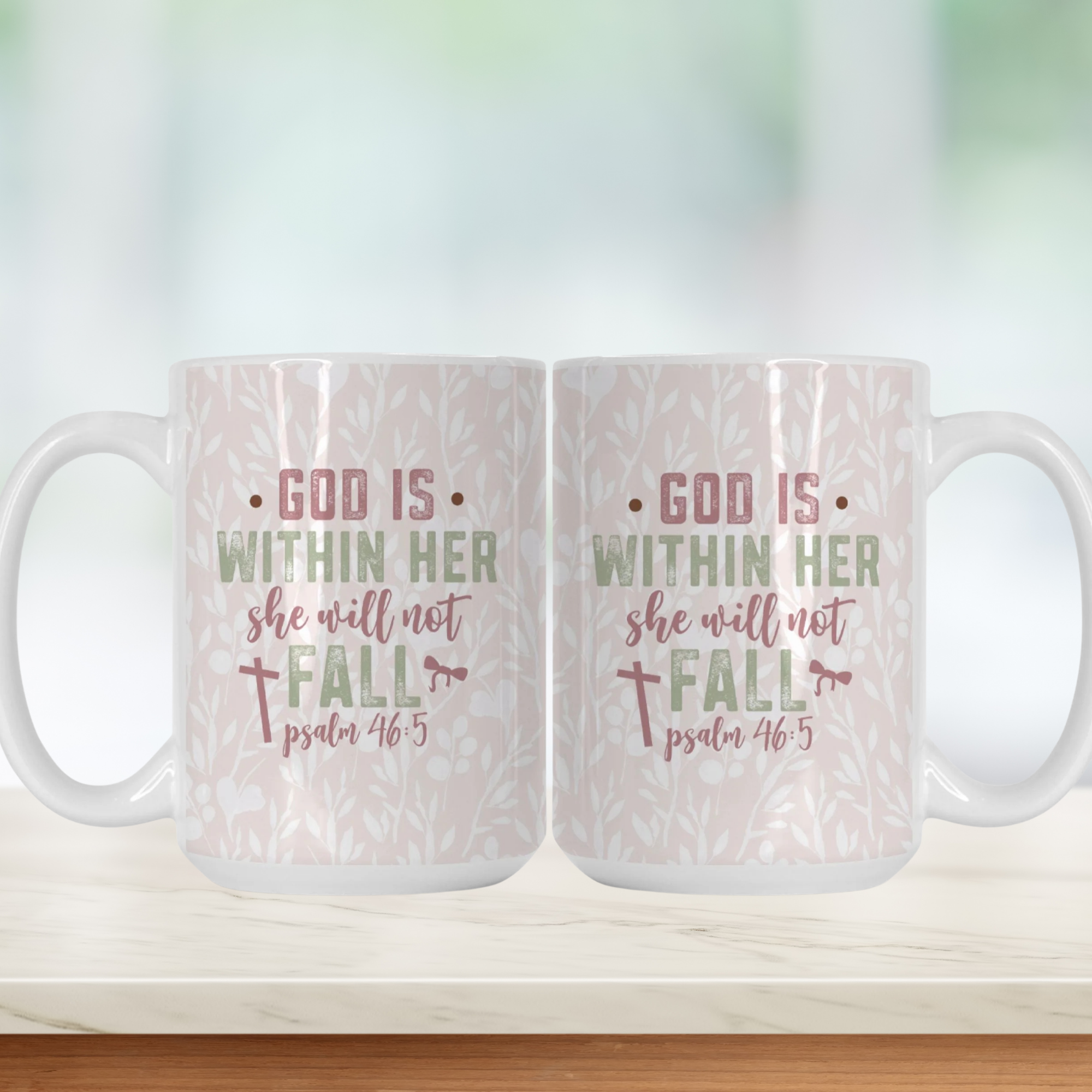 Two white mugs with a pink floral pattern and text 'God Is Within Her She Will Not Fall, Psalm 46:5' on a light background