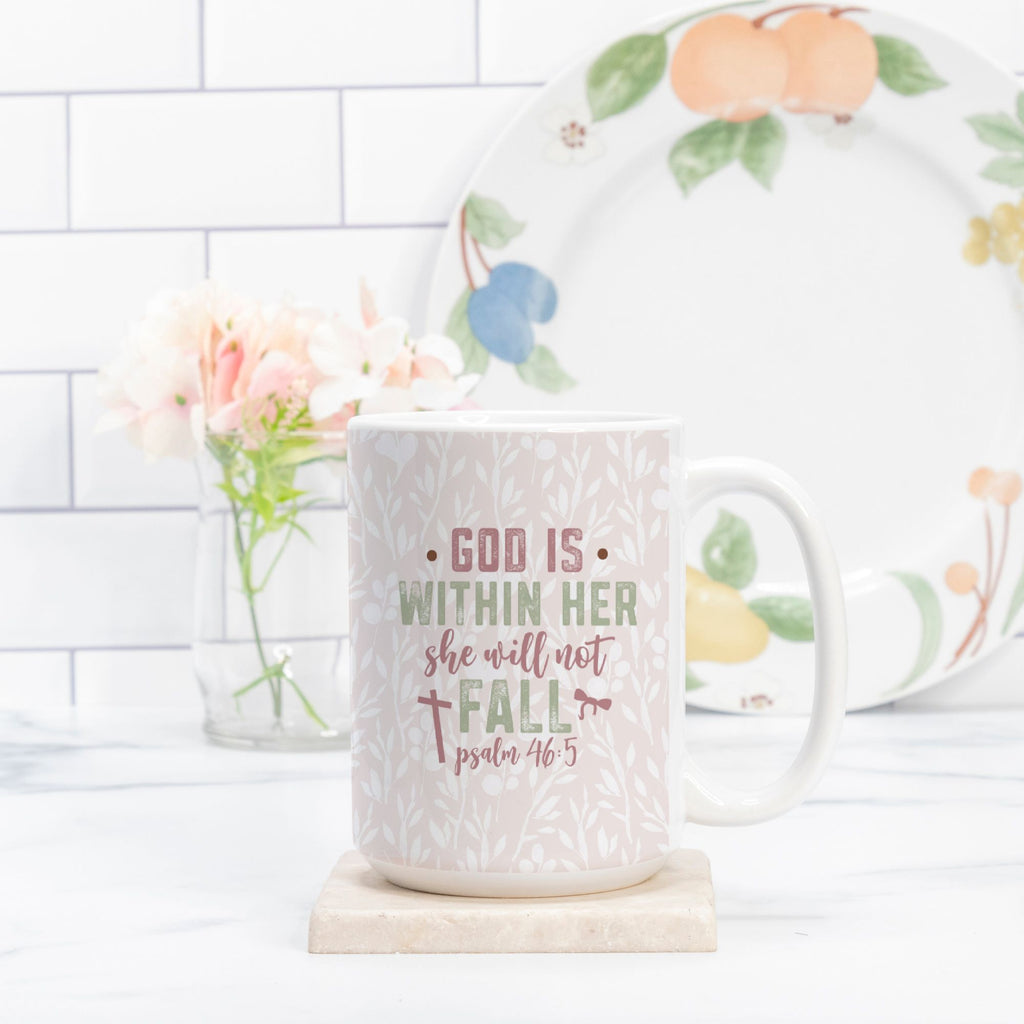 Mug with motivational bible quote and floral plate in the background