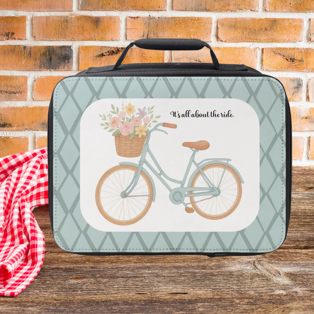  insulated lunch bag with bicycle and flowers design on a wooden surface with brick background