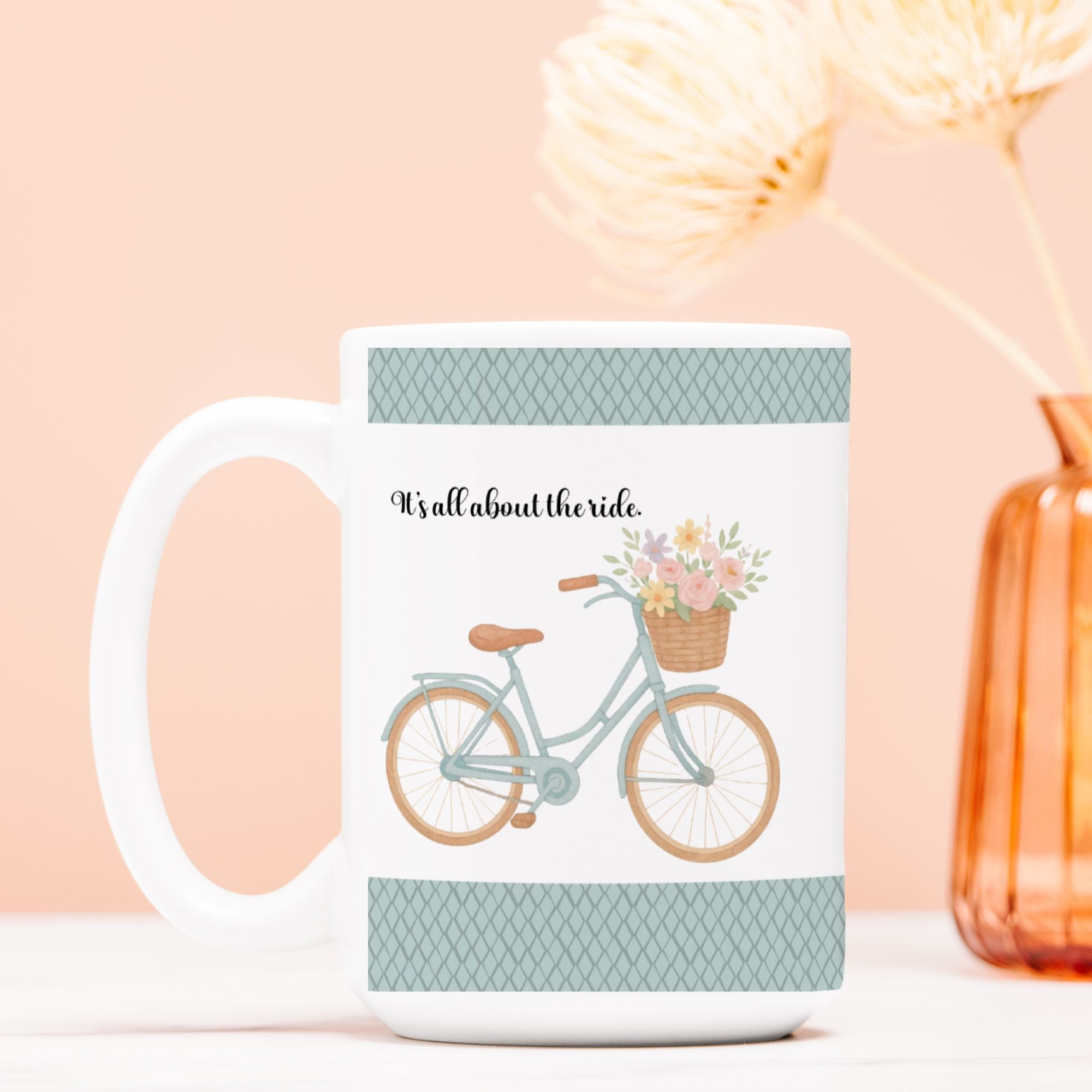 Mug with bicycle and floral design on a light pink background