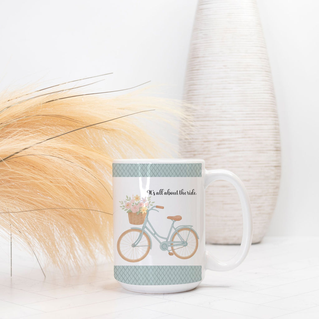 Mug with bicycle and floral design on a white surface with decorative elements