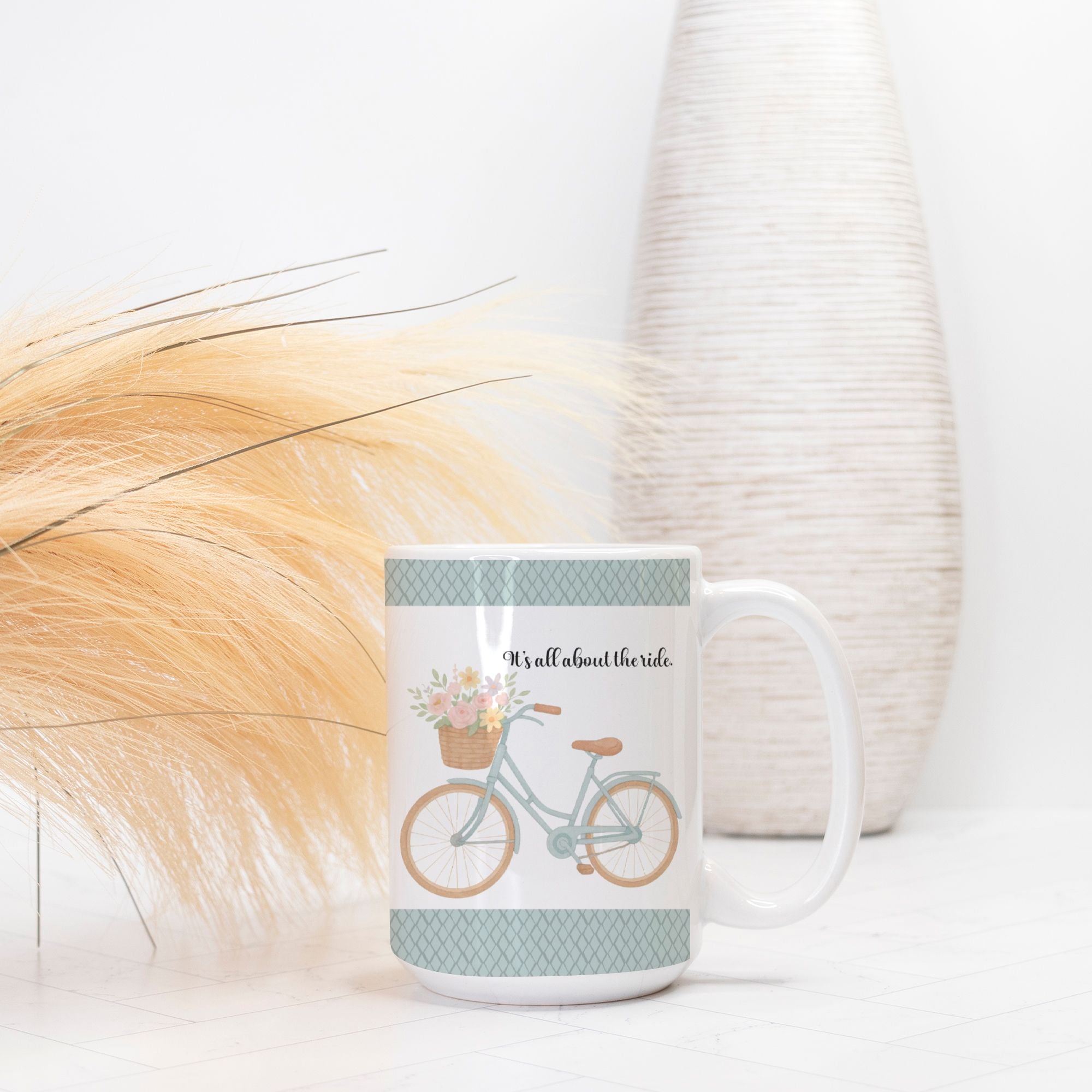 Mug with bicycle and floral design on a white surface with decorative elements