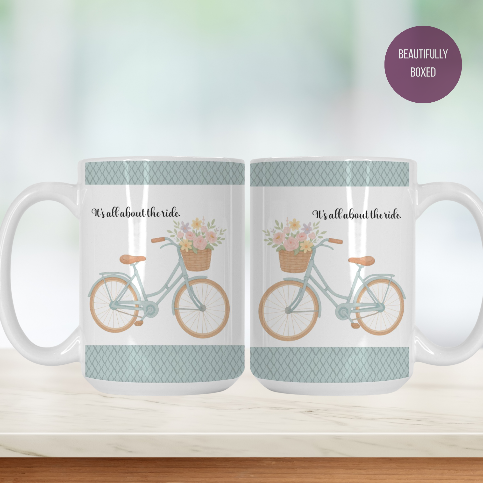 mug with a design of a bicycle with a floral basket and text 'It's all about the ride' on a kitchen counter.
